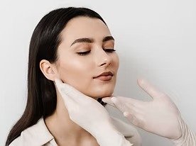 imgi_6_facebuilding-doctor-examines-beauty-face-woman-consultation-with-plastic-surgeon-white-bac