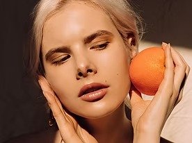 imgi_7_young-woman-holding-orange-fruit